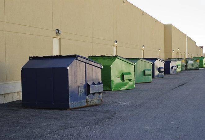 metal waste containers sit at a busy construction site in Copiague